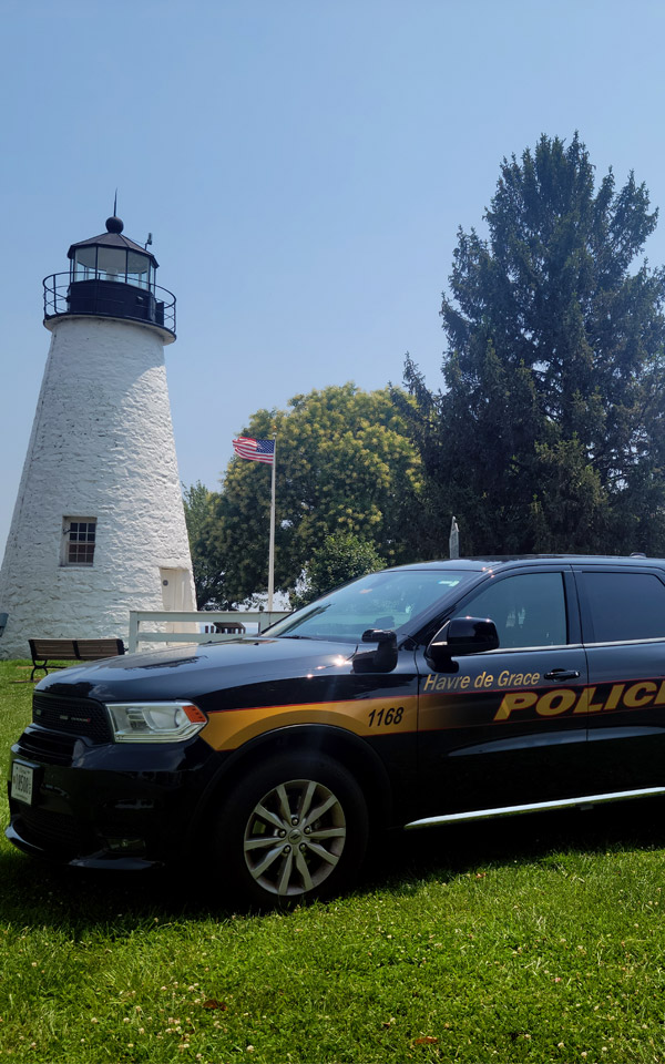 police cruiser by lighthouse