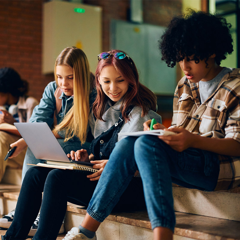 group of high school students learning in hallway